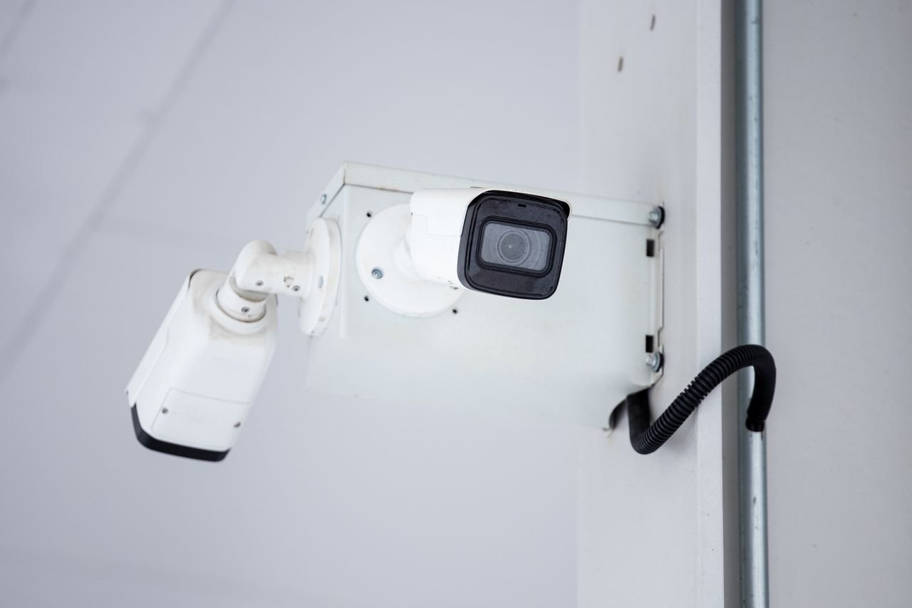 A close-up shot of a modern, mounted surveillance camera highlighting security and surveillance.